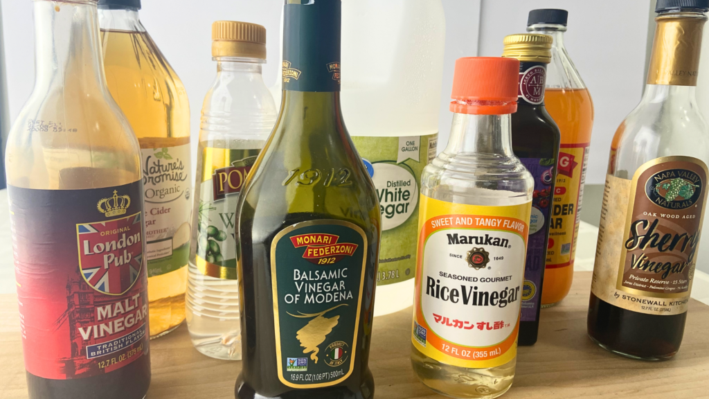 Assortment of vinegars including malt vinegar, apple cider vinegar white wine vinegar, Balsamic Vinegar of Modena, distilled white vinegar, rice vinegar balsamic vinegar, apple cider vinegar dnf sherry vinegar.