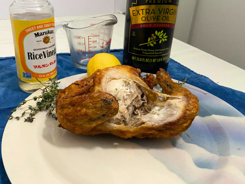 a cooked chicken that was marinated in a rice wine vinegar and olive oil marinade sitting on a plate