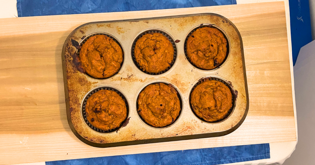 overview shot from above of finished banana nut vegan muffins in muffin pan