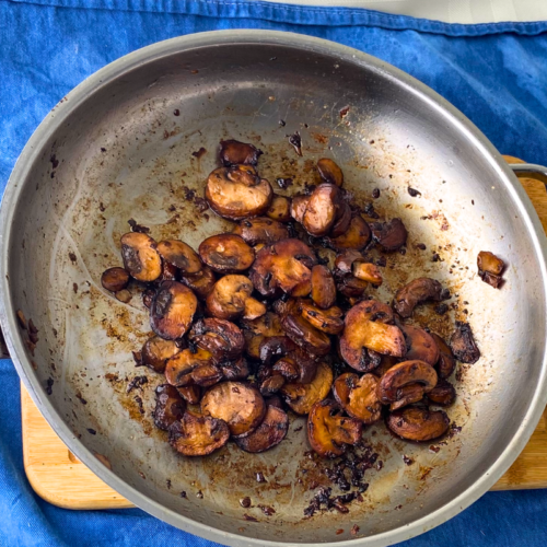 Mushrooms sauteed in a pan with small batch red wine vinegar glaze