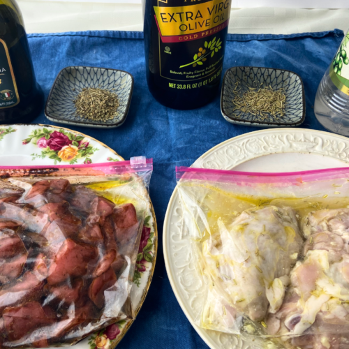 Marinating beef cubes and marinating chicken thighs in bags with balsamic vinegar, olive oil, white wine vinegar, and spices next to them.
