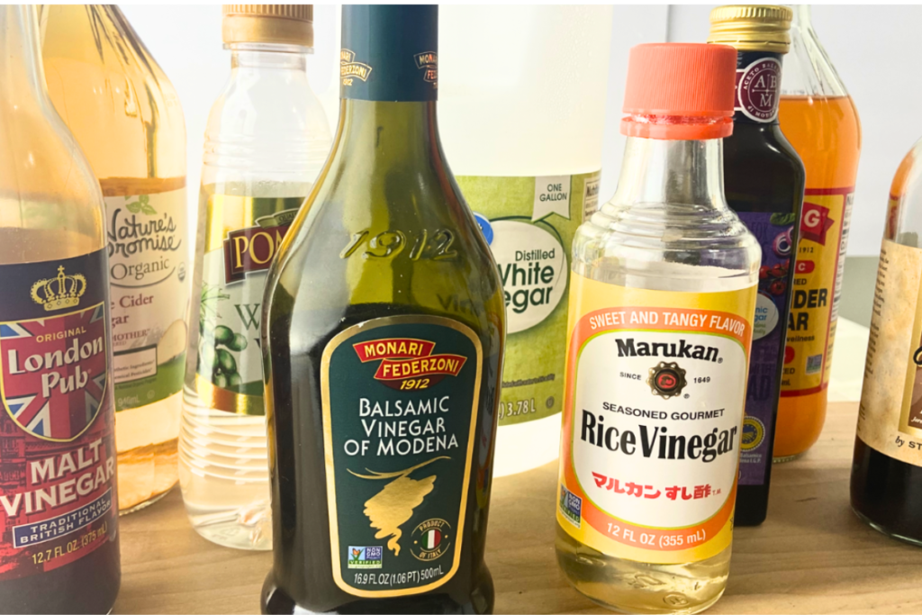 Collection of vinegars including malt vinegar,apple cider vinegar, balsamic vinegar, rice wine vinegar, distilled white vinegar, and sherry vinegar
