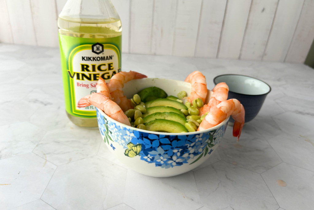 A Japanese poke rice bowl with rice vinegar sushi rice, shrimp, avocado, and soy beans